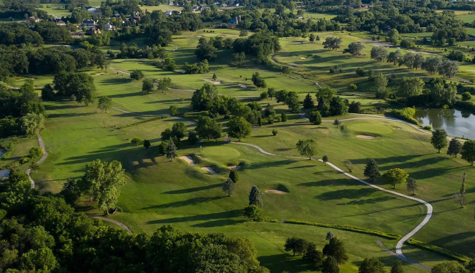 Aerial view of a golf course at sunset